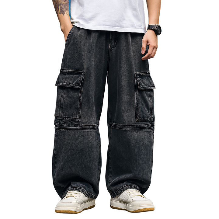 Person wearing black cargo pants and white sneakers on a white background