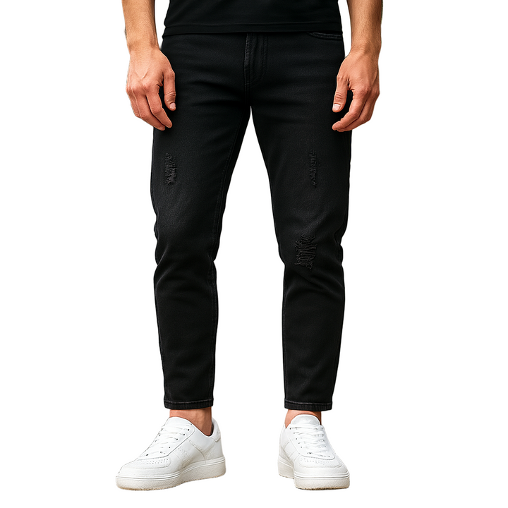 Person wearing black distressed jeans and white sneakers